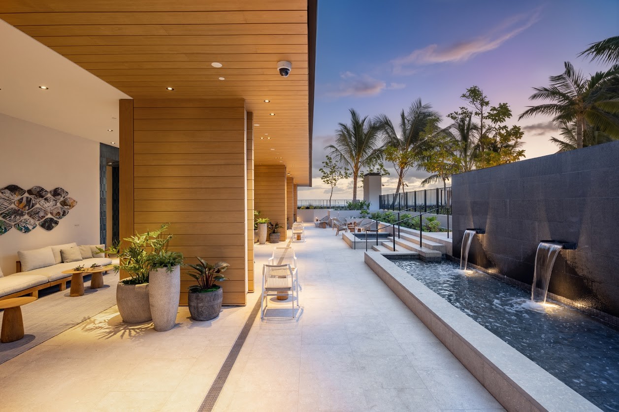 A modern house with a pool and waterfall.